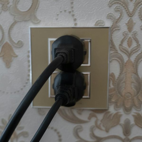 Wall outlet with two plugs connected